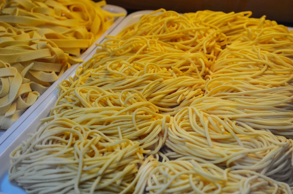 Fresh Italian pasta noodles in a market display – Authentic homemade pasta stock photo