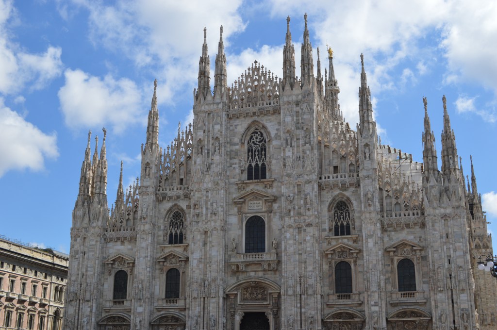 Milan Cathedral with Gothic spires under a blue sky
