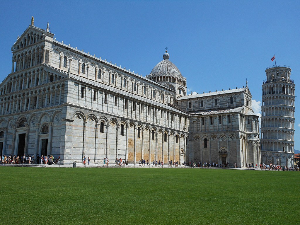 Pisa Cathedral with green lawn and Romanesque architecture