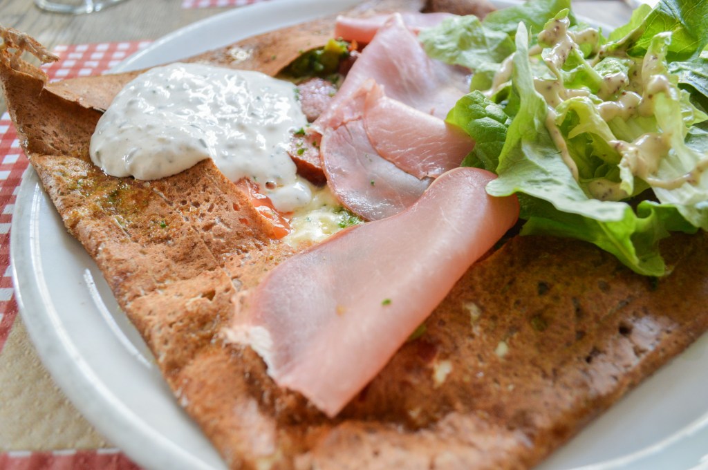 French buckwheat galette with ham, cheese, and fresh lettuce – Classic French cuisine stock photo