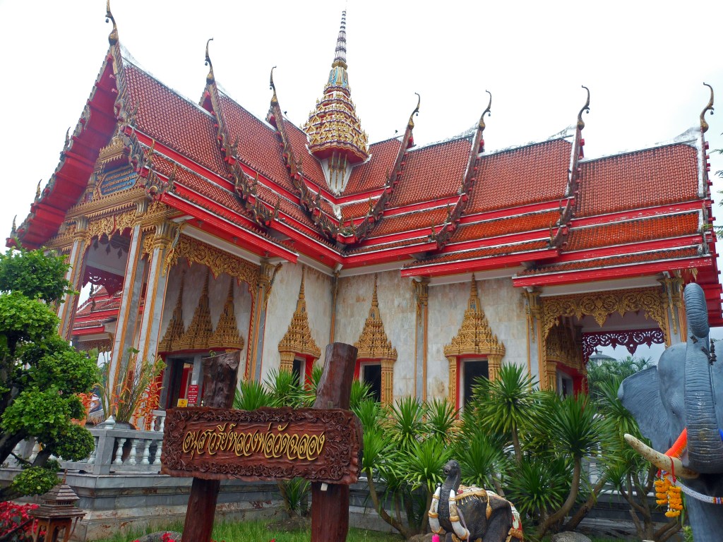 Traditional Thai Buddhist temple with red and gold roof in Thailand