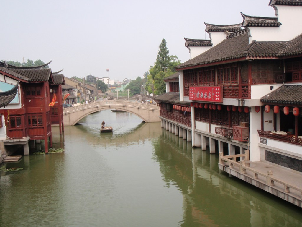 Traditional Suzhou water town with a stone bridge and ancient wooden houses – A famous Chinese canal city
