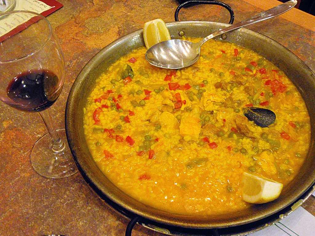 Traditional Spanish seafood paella with saffron rice and fresh lemon – Classic Spanish dish stock image