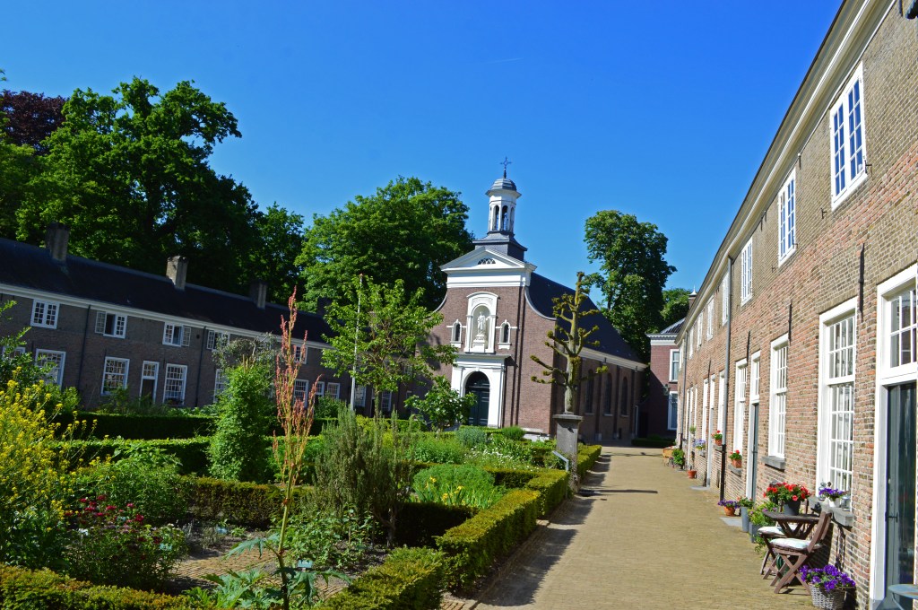 begijnhof courtyard and chapel in breda surrounded by lush greenery