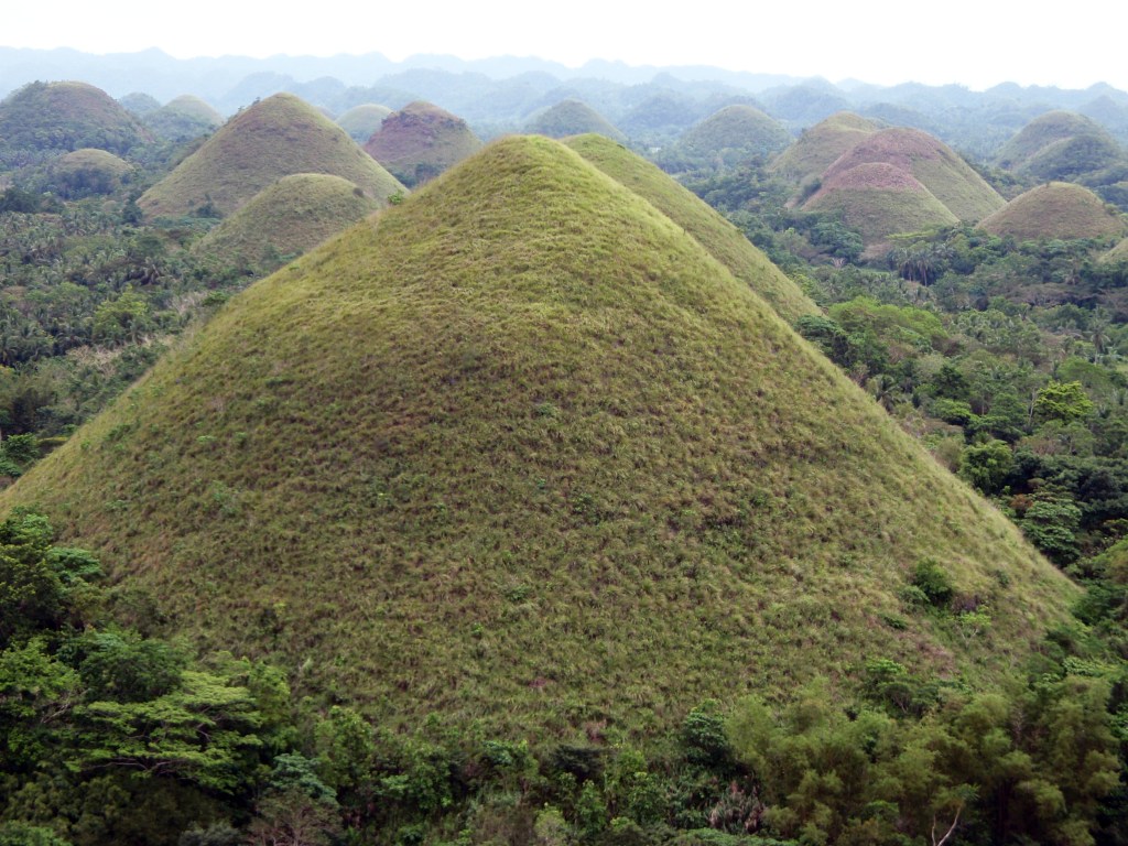 chocolate hills covered in green grass on bohol island - Bohol stock photos