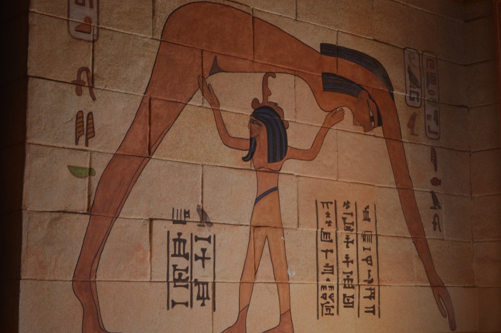 Ancient Egyptian wall painting with hieroglyphs, depicting a mythological scene