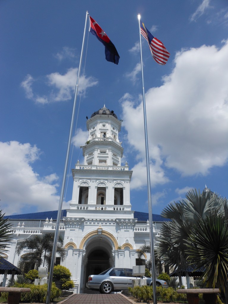 The Sultan Abu Bakar Mosque in Johor Bahru with Malaysian and Johor state flags flying.