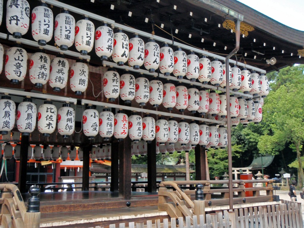 Rows of illuminated Japanese paper lanterns with kanji characters – A symbol of festivals and temples