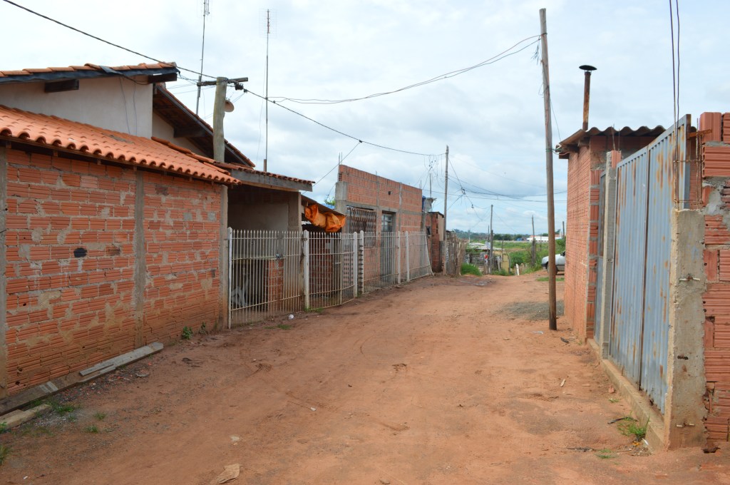 Rustic village street with red dirt road and houses in São Pedro, Brazil – travel stock photo