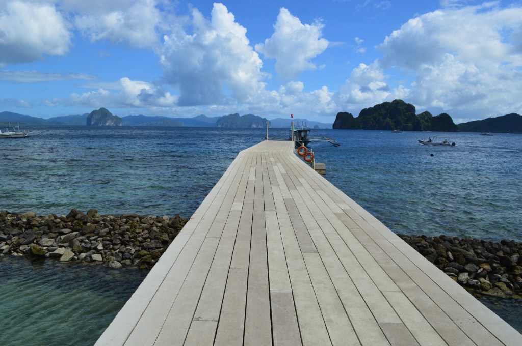 Scenic long wooden pier extending into the sea in El Nido, Palawan – El Nido stock photo