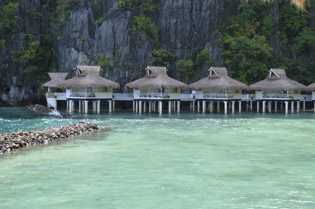 overwater cottages surrounded by turquoise water in el nido - El Nido stock photos