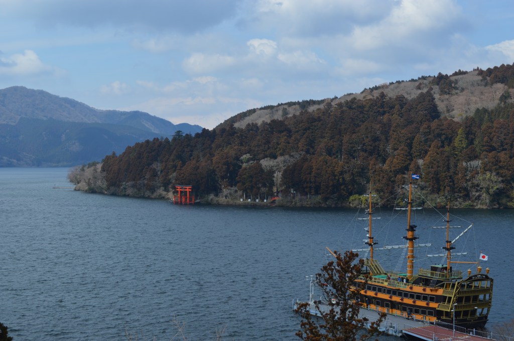 Scenic view of Lake Ashi in Hakone with red torii gate and sightseeing pirate ship - Hakone stock photos