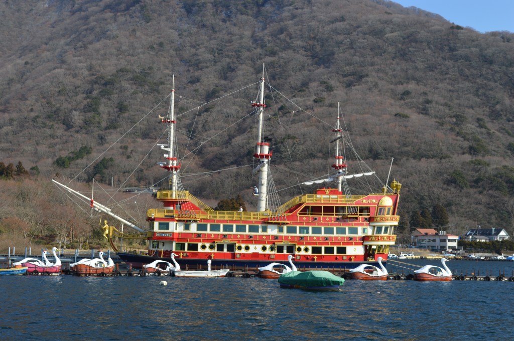 Scenic view of Lake Ashi in Hakone with red torii gate and sightseeing pirate ship - Hakone stock photos