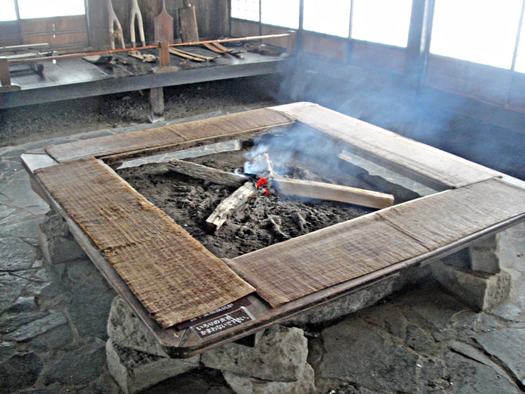 Traditional Japanese irori hearth with firewood burning inside a historic farmhouse- Hida-Takayama stock photos