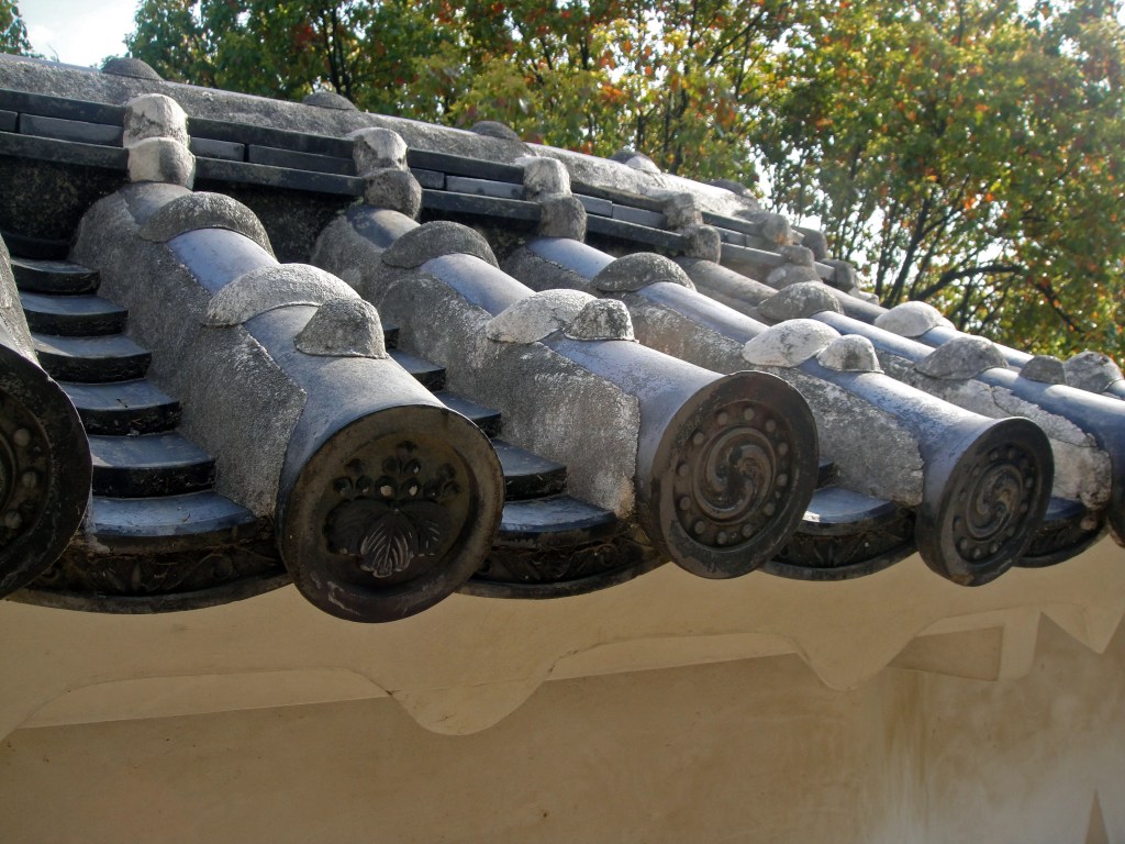 Ornate roof tiles with family crests at Himeji Castle – Himeji stock photos