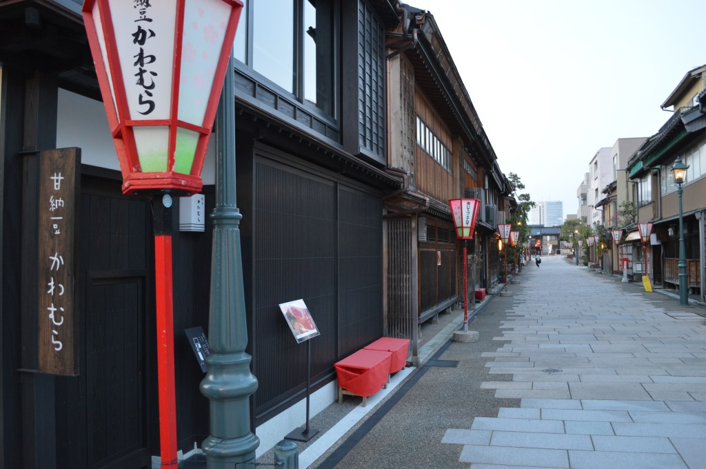 Traditional wooden buildings and red lanterns line a quiet street in the historic Higashi Chaya District in Kanazawa, Japan.-Ishikawa stock photos