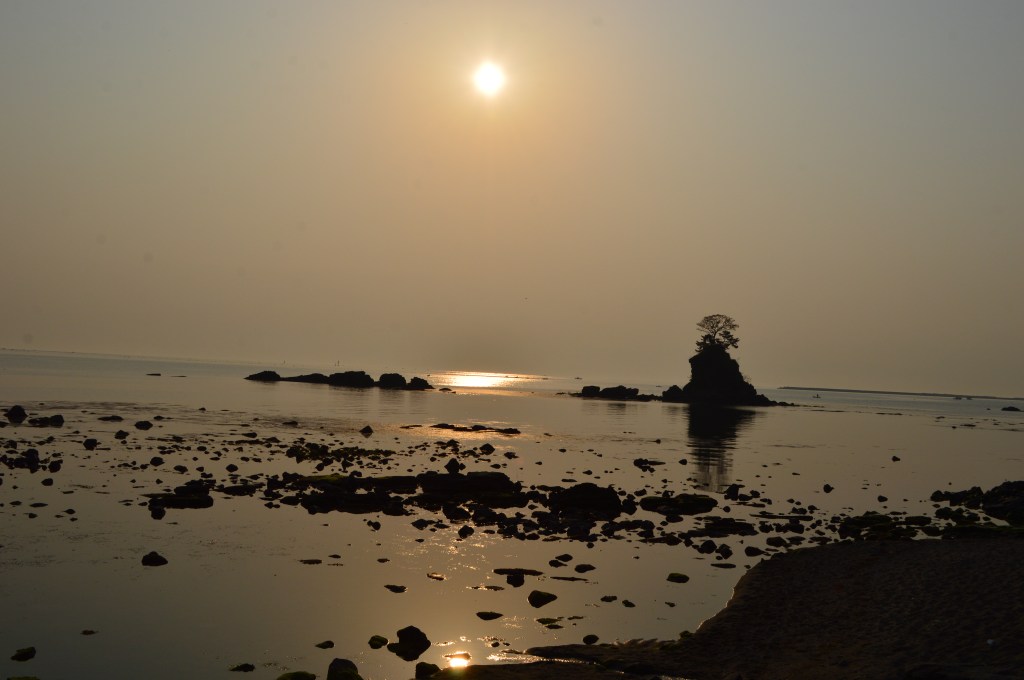 Sunrise over Amaharashi Coast in Toyama, Japan with a rocky islet silhouetted against the sea - Wajima stock photos